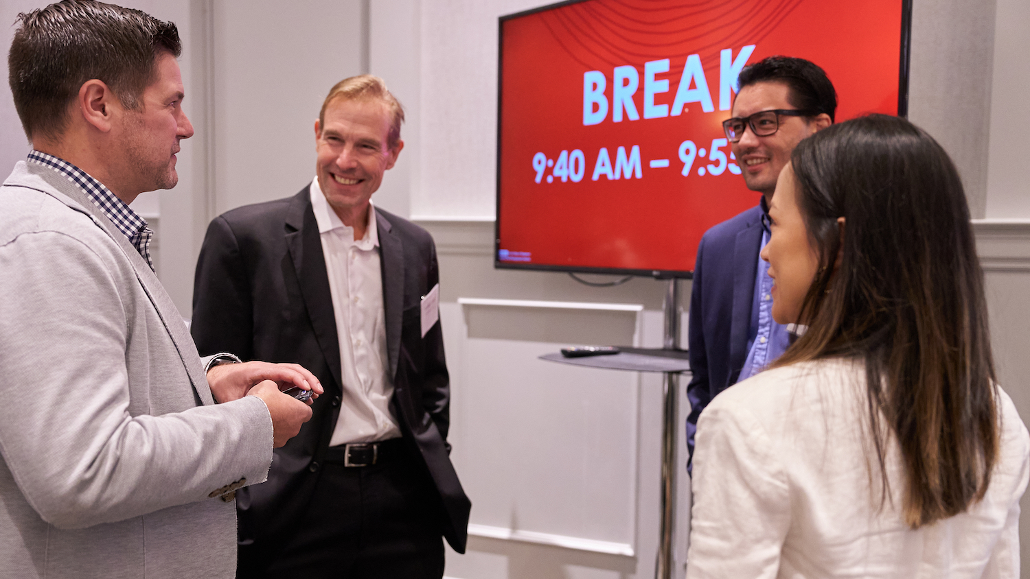 four professionals talking